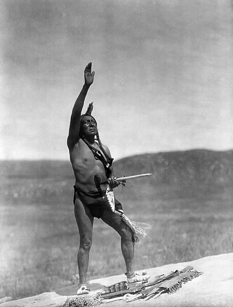 SIOUX INVOCATION, c1907. A Sioux Native American man raising his hand toward the sky to invoke the spirits. Photographed by Edward S. Curtis, c1907
