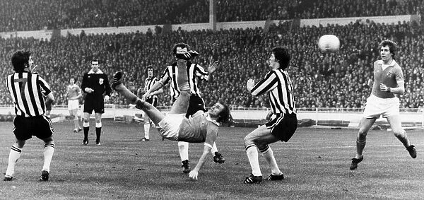 SOCCER MATCH, 1976. Dennis Tueart of Manchester City scores the winning goal against Newcastle United with an overhead kick, 1976