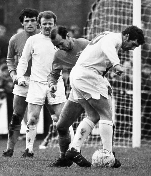 SOCCER MATCH, c1970. Soccer match between Leeds United and Sutton United, c1970. Johnny Giles of Leeds (with ball) is watched by Billy Bremner and two Sutton players