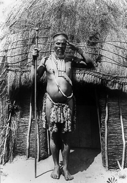 SOUTH AFRICA: ZULU CHIEF. Zulu chief standing in front of a hut in South Africa