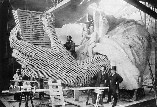 STATUE OF LIBERTY, 1883. The Statue of Liberty under construction in Paris, c1883. Its sculptor, Frederic Bartholdi, stands second from right