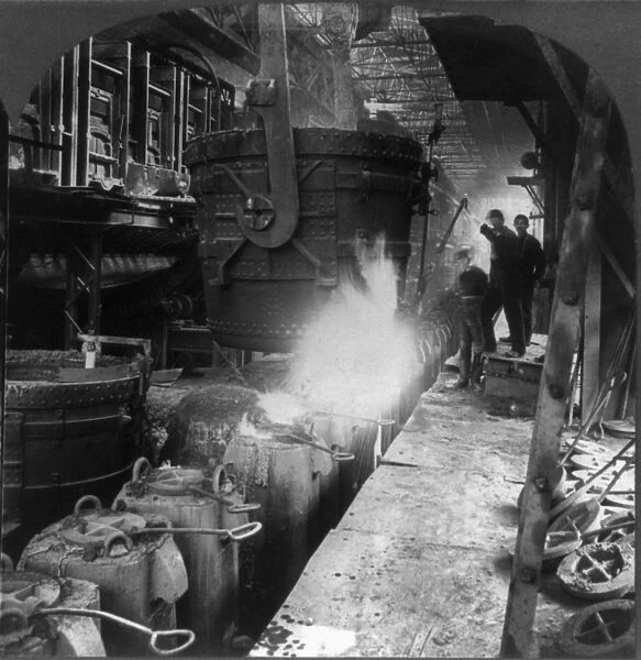 STEEL MILL, c1905. A ladle pouring molten steel into molds at a foundry in Pittsburgh
