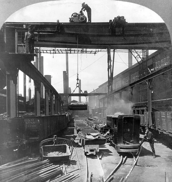 STEEL MILL, c1905. Large cranes loading finished steel products into railroad cars