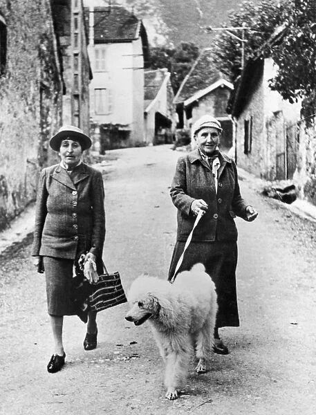 STEIN AND TOKLAS, 1944. American writer Gertrude Stein (1874-1946) photographed in southeastern France in September 1944 with her companion, Alice B. Toklas (left)