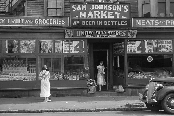 STOREFRONT, 1937. A market in Manchester, New Hampshire. Photograph by Edwin Locke