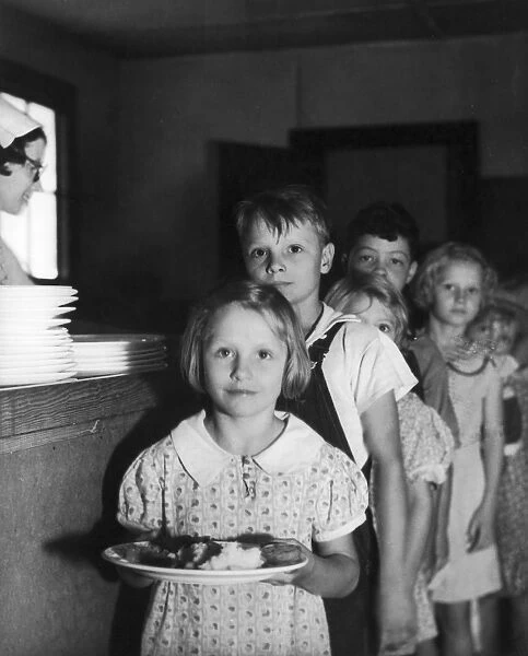 Students lined up for their hot lunch at Oak Hill School, Chattanooga, Tennessee, September 1936. The children are benefitting from a Works Progress Administration (WPA) program