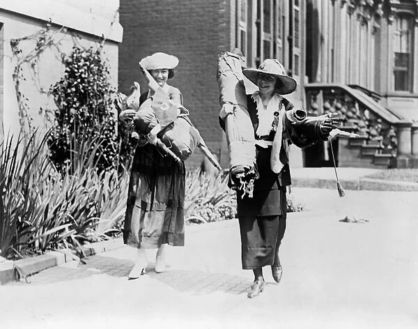 SUFFRAGETTES, c1920. Suffragettes Julia Emory and Bertha Graf carrying bundles of flags