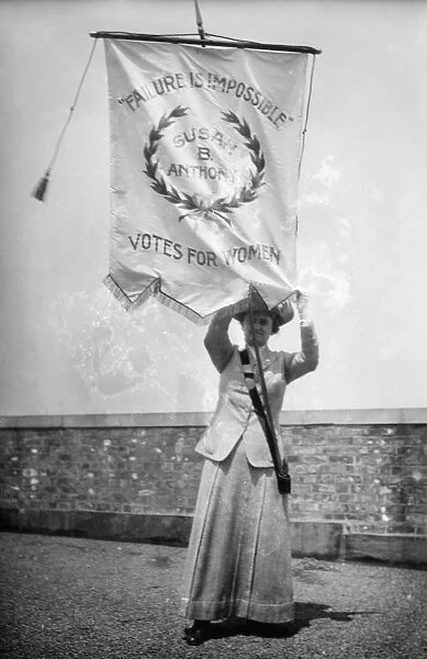 SUFFRAGIST, c1912. American suffragist Florence Jaffray Daisy Harriman (1870-1967) holding a banner bearing the words of Susan B. Anthony, Failure Is Impossible. Photographed c1912