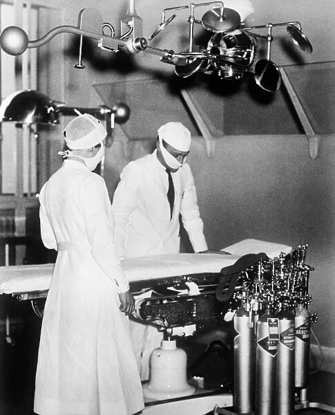 SURGEONS, c1930. Surgeons in an operating room. Photograph, c1930
