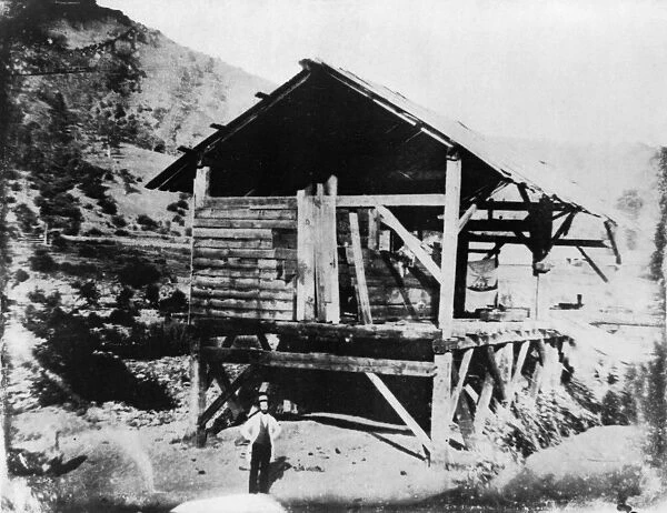 SUTTERs MILL, c1850. James Marshall, prospector, standing in front of Sutters Mill