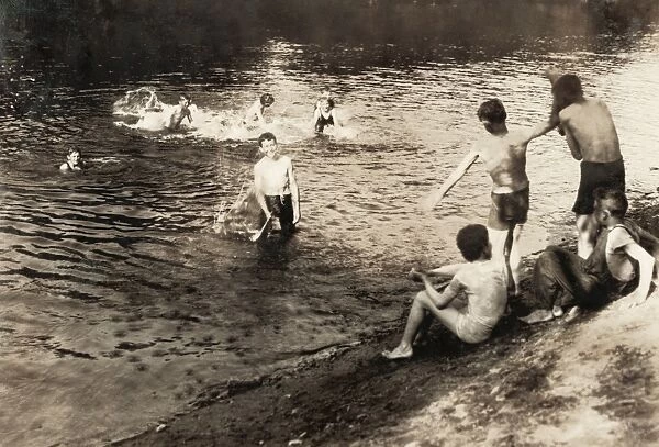 SWIMMING HOLE, 1916. A group of teenage boys at a swimming hole after a day of