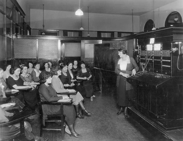 TELEPHONE EXCHANGE, 1915. A telephone company switchboard training class, c1915