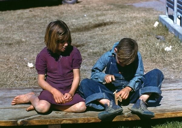 TEXAS: CHILDREN, 1942. A girl watching a boy build a model airplane at an FSA labor