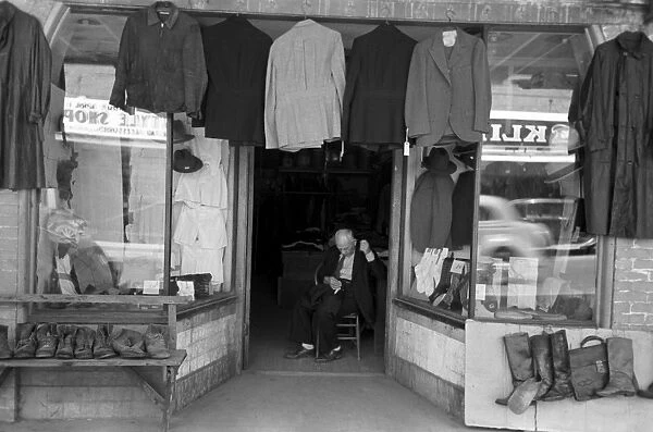 TEXAS: STOREFRONT, 1939. Clothing store with a tailor in the doorway, Mexican district