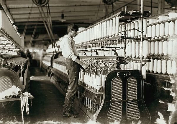 TEXTILE MILL, 1908. A warper at his machine at the Catawba Cotton Mill in Newton, North Carolina