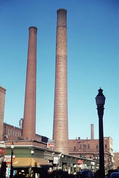 TEXTILE SMOKESTACKS, 1941. Large textile mill smokestacks in Lowell, Massachusetts