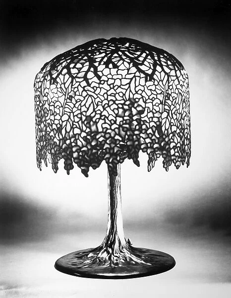 TIFFANY LAMP. Wisteria leaded glass and bronze table lamp in the form of a tree