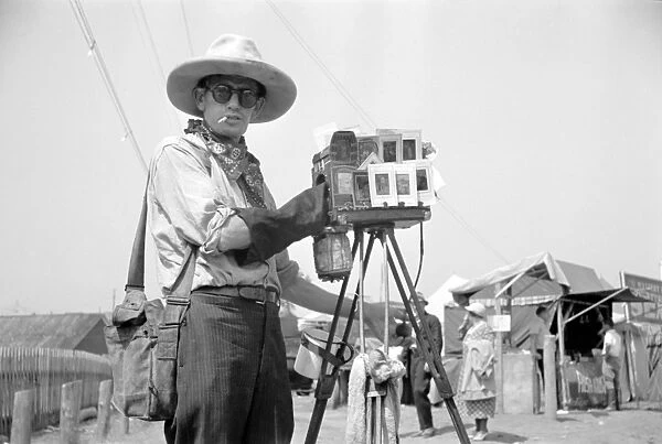 TINTYPE PHOTOGRAPHER, 1936. A tintype photographer at a fair in Morrisville, Vermont