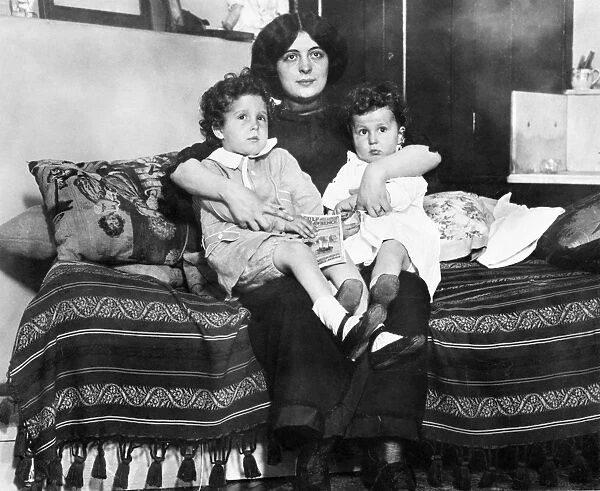 TITANIC: SURVIVORS, 1912. Young survivors of the Titanic Louis (left) and Michel Navratil on their mothers lap after being reuinted. Photographed 1912