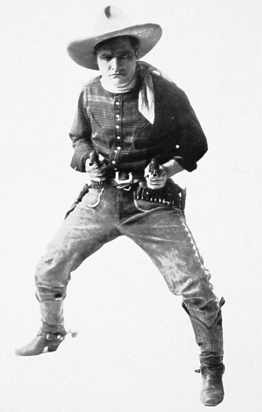 TOM MIX (1880-1944). American film actor. Publicity still for the film, Fighting for Gold (1919)