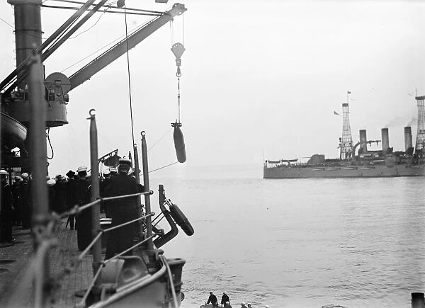 TORPEDO, 1913. Sailors hauling torpedoes on board an American warship. Photograph, 1913