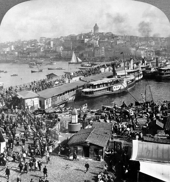 TURKEY: ISTANBUL, c1913. Crowds of pedestrians crossing the Galata Bridge over