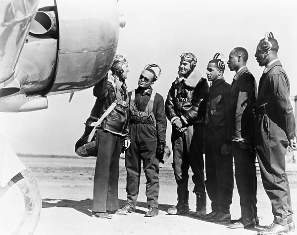 TUSKEGEE AIRMEN, 1942. Members of the first group of African American pilots in the history of the U. S. Army Air Corps at Tuskegee, Alabama, with Major General George E. Stratemeyer. Photographed March 1942