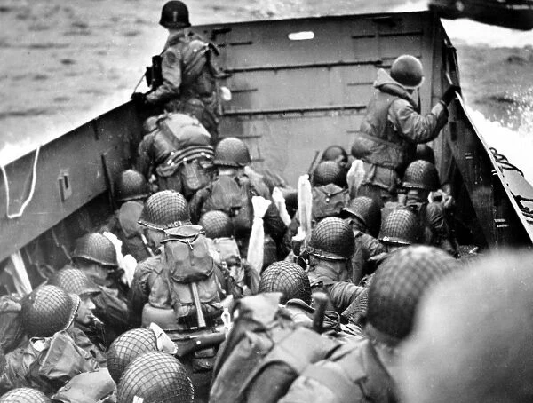 U. S. Army assault troops aboard the Coast Guard landing craft off the coast of Normandy, France, 6 June 1944