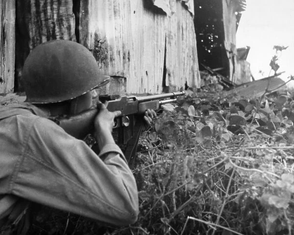 U. S. Army soldier of the 2nd Battalion, 503rd Parachute Infantry with a Browning automatic rifle during combat at San Jose, Mindoro, Philippines, 13 December 1944
