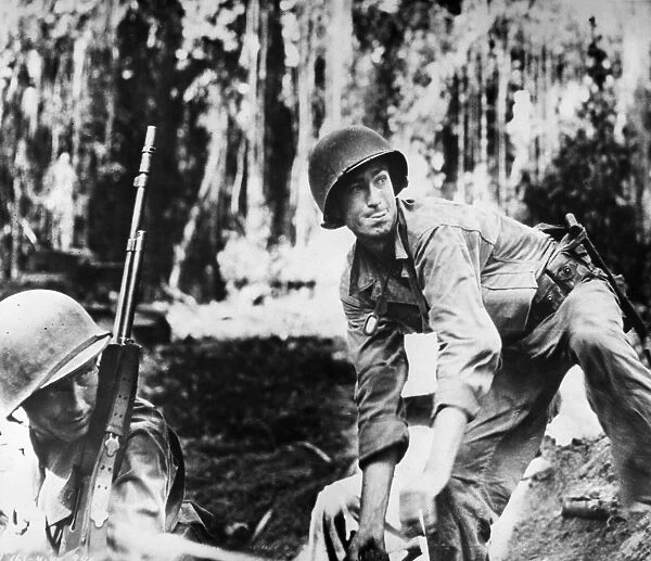 U. S. Army soldier prepares to throw a hand grenade during the fighting at Empress Augusta Bay, Bougainville, New Guinea. Photographed late 1943