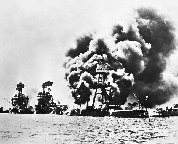 Three U. S. battleships stricken during the Japanese attack on Pearl Harbor, 7 December 1941. Left to right: USS West Virginia, severely damaged; USS Tennessee, damaged; USS Arizona, sunk