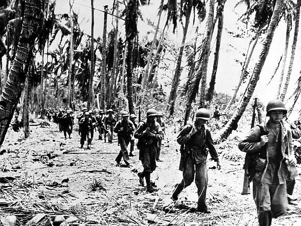 U. S. Marines advance into the village of Matanikou during the Battle of Guadalcanal, Solomon Islands, 24 December 1942