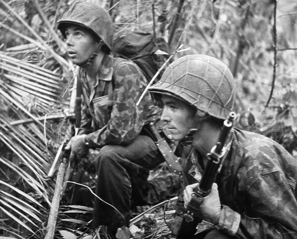 Two U. S. Marines on patrol at Cape Torokina, Bougainville Island, New Guinea. Photographed late 1943