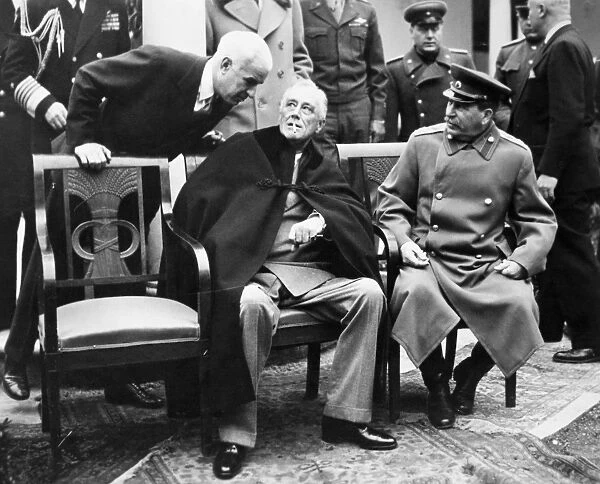 U. S. Secretary of State Edward R. Stettinius (left), U. S. President Franklin D. Roosevelt (center), and Soviet Premier Joseph Stalin photographed on the patio at Livadia Palace, Yalta, Crimea, February 1945