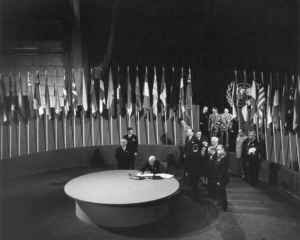 U. S. Secretary of State Edward R. Stettinius signs the Charter of the United Nations on behalf of his country at the San Francisco Opera House, June 26, 1945