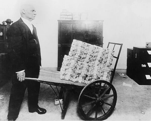 U. S. TREASURY, c1915. An employee wheels $75, 000 in mutilated currency to the vaults