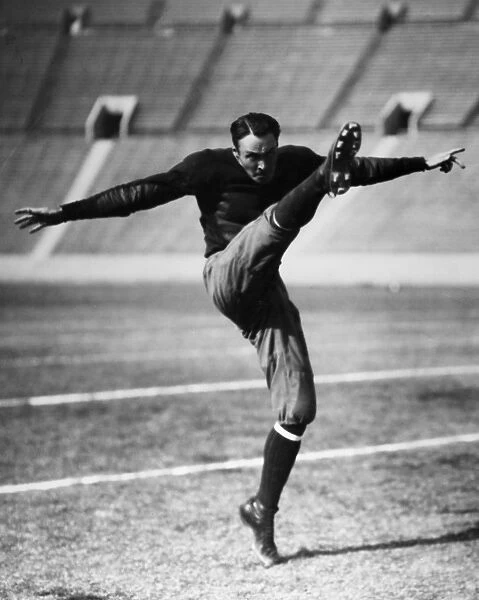 An unidentified American football player kicking the ball, early 20th century