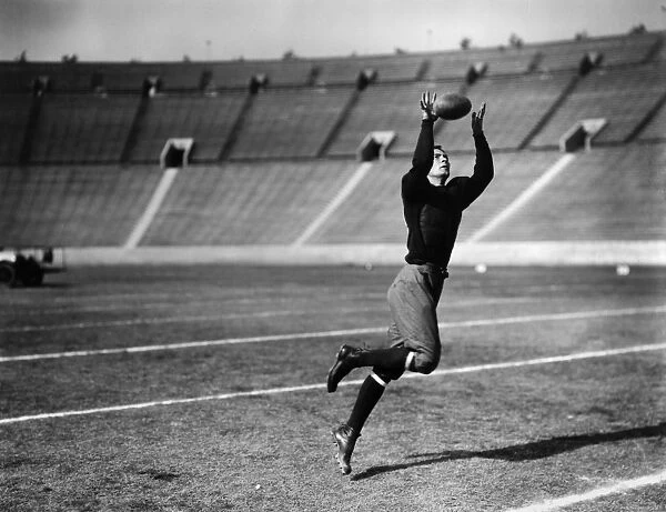 An unidentified American football player making a catch, early 20th century
