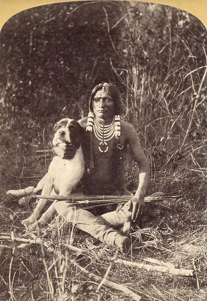 UTE MAN WITH DOG, c1874. A young Ute man with his dog, in Utah. Photograph by John K. Hillers, c1874