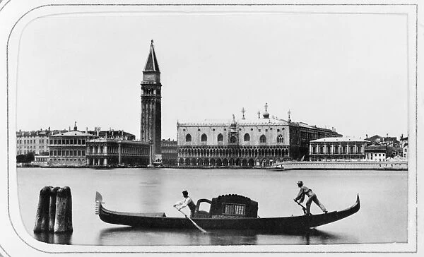 VENICE: ST. MARKs SQUARE. A gondola on a waterway in Venice, Italy; the Doges Palace