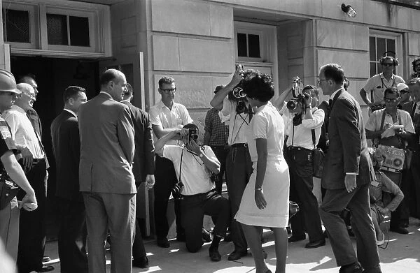 Vivian Malone entering Foster Auditorium to become one of the first black students to attend the University of Alabama on 11 June 1963, passing through a crowd that includes photographers, National Guard members, and Deputy U. S. Attorney General Nicholas Katzenbach. Photographed by Warren K. Leffler