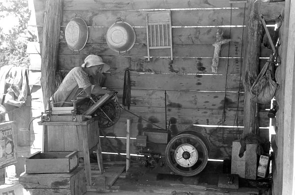 WASHING MACHINE, 1940. Mrs. Hutton using an electric washing machine in Pie Town, New Mexico