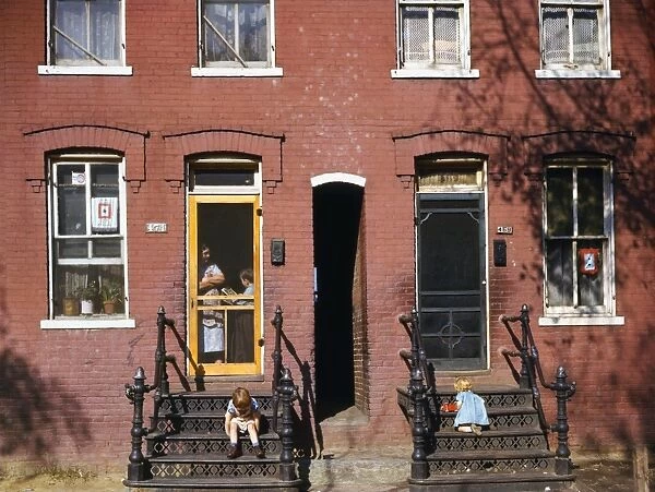 WASHINGTON D. C. : HOUSES. Children playing on the steps of row houses in Washington, D