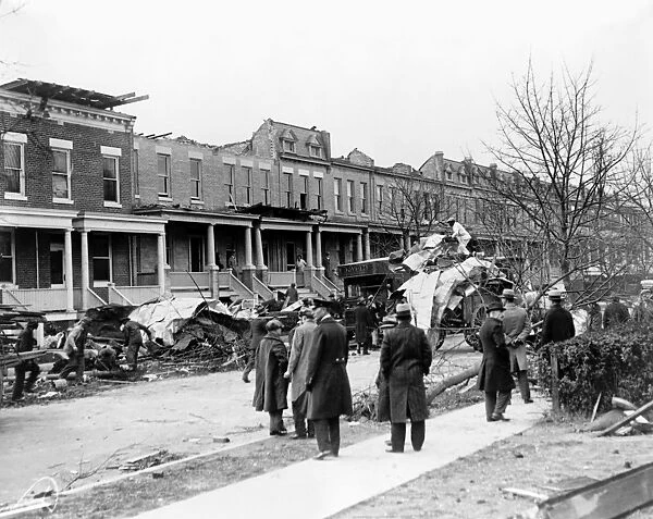 WASHINGTON, D. C. : HOUSES. Men on a sidewalk watching debris being cleaned up in