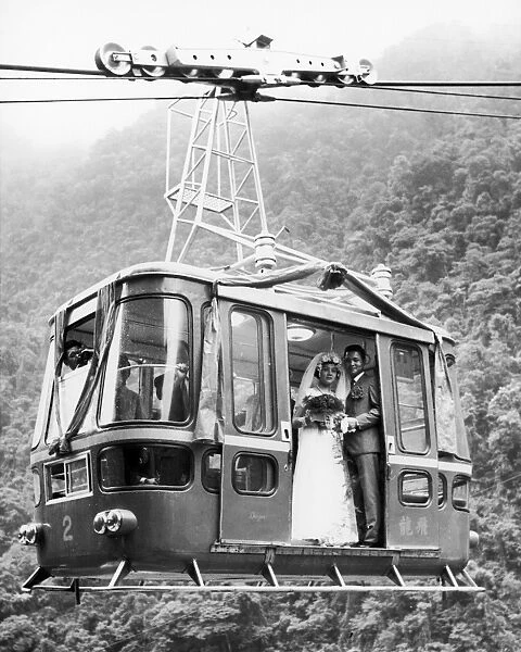 WEDDING: CABLE CAR, 1970. A young Taiwanese couple, she a cable car conductor, he a cable car operator, are married in a supended cable car north of Taipei, Taiwan, October 1970