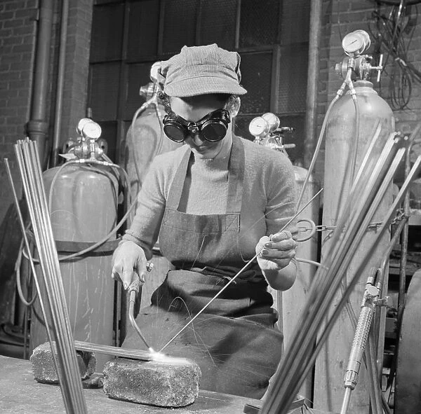 WELDING STUDENT, 1942. Young woman learning to weld at a vocational school, United States