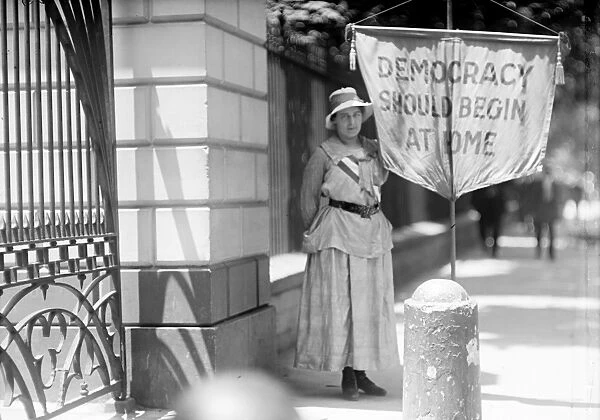 WHITE HOUSE: SUFFRAGETTE. A suffragette picketing in front of the White House, Washington, D