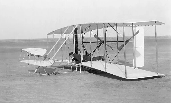 Wilbur Wright in prone position in damaged glider after unsuccessful trial, Kitty Hawk, North Carolina. Photographed by Orville Wright on 14 December 1903