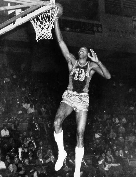 WILT CHAMBERLAIN (1936-1996). American basketball player. Playing for the Philadelphia Warriors in 1962