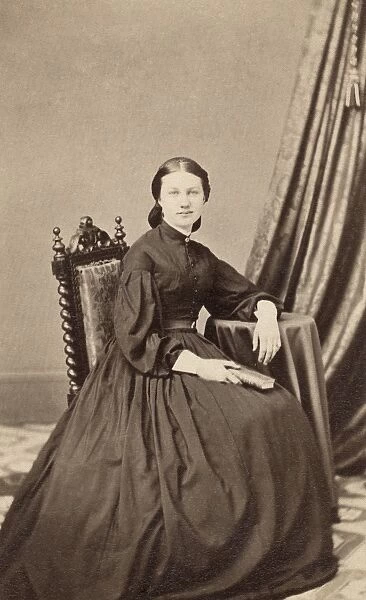 WOMAN, 19th CENTURY. A seated woman, photographed by Webster & Popkins in Hartford